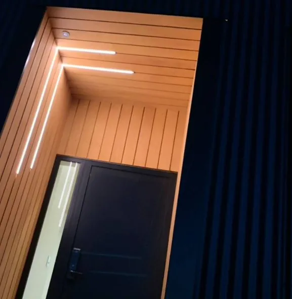LED strip lighting in a timber-lined entry set into dark cladding