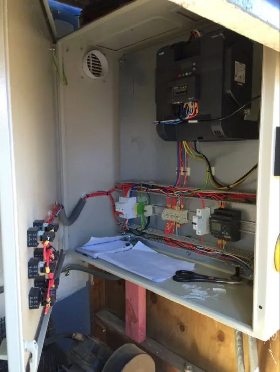 Open control cabinet with a drive, breakers and neat wiring